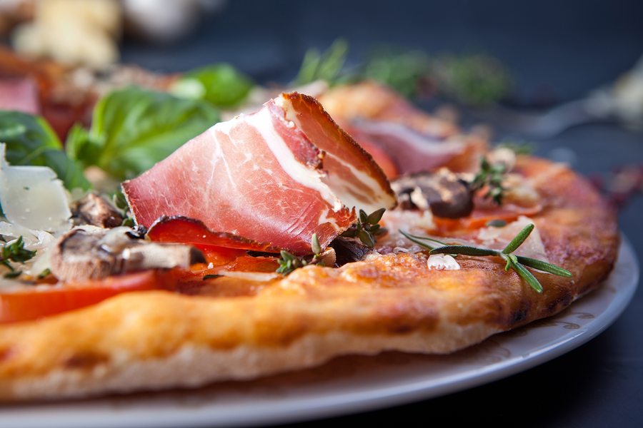 Pizza with Ham and Mushrooms on dark background