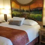 bed with decorative headboard in the king ADA accessible room | El Bonita Motel